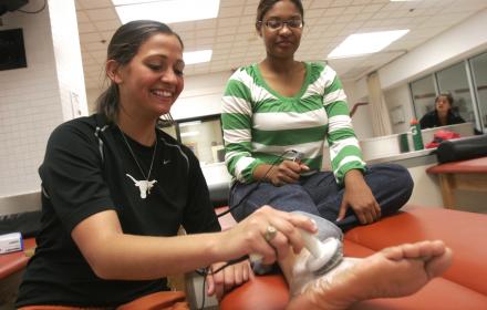 Kinesiology student performing test on patient.
